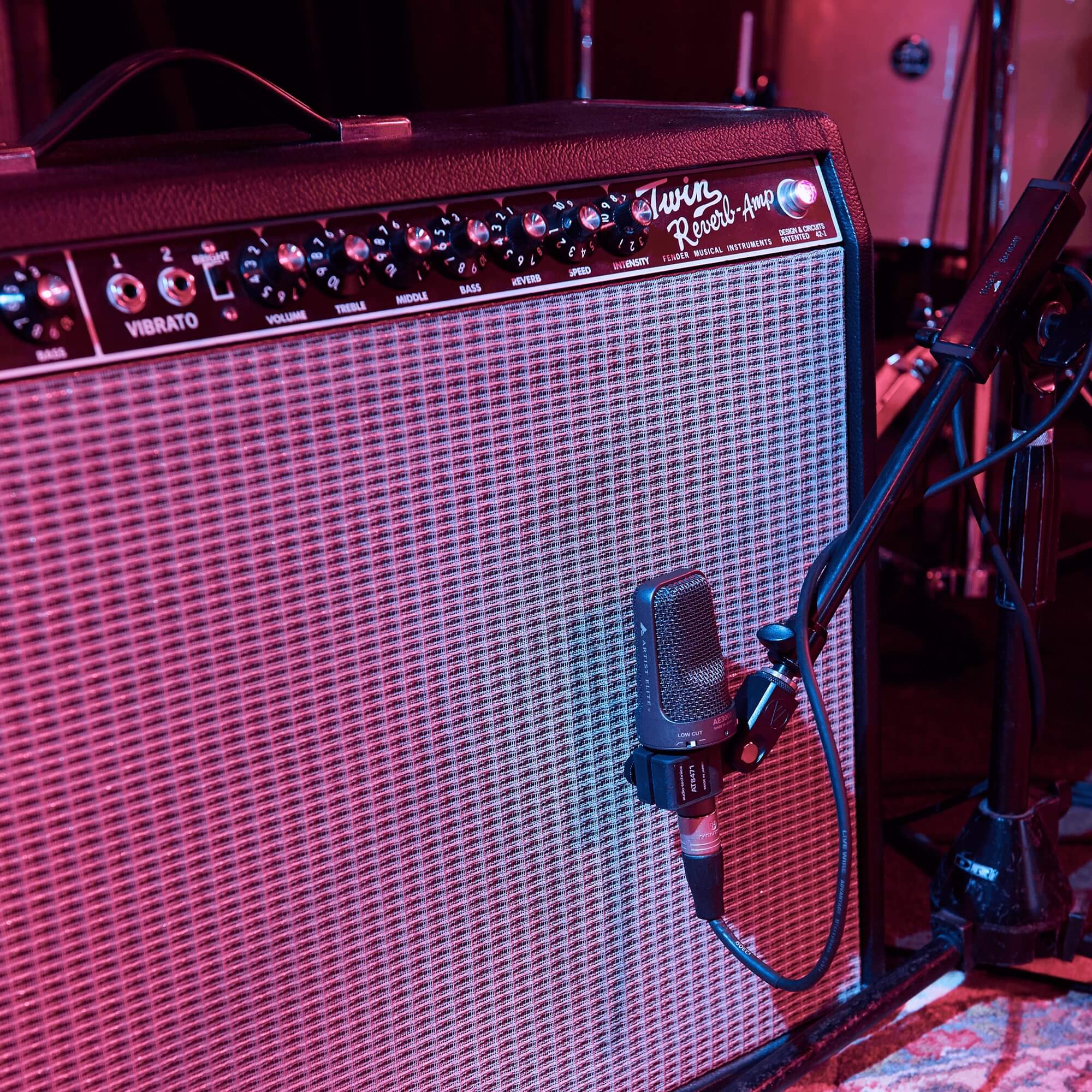 Audio-Technica AE3000 - Cardioid Condenser Instrument Microphone, mounted in front of an amplifier