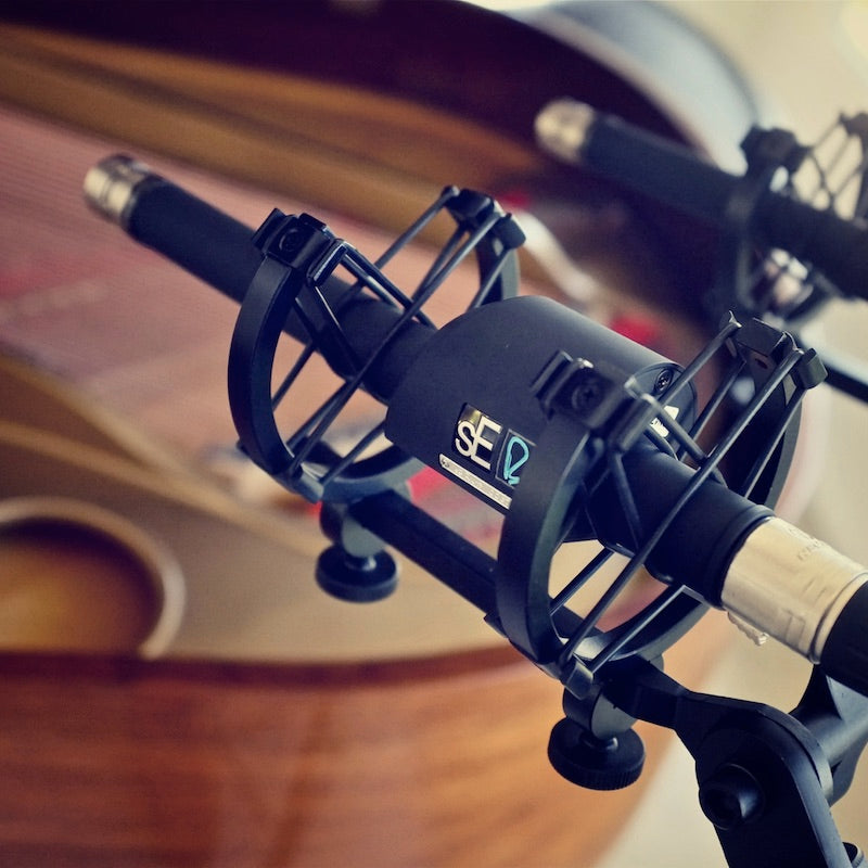 Two sE Electronics RN17 Small Diaphragm Microphones in shock mounts mixing a piano