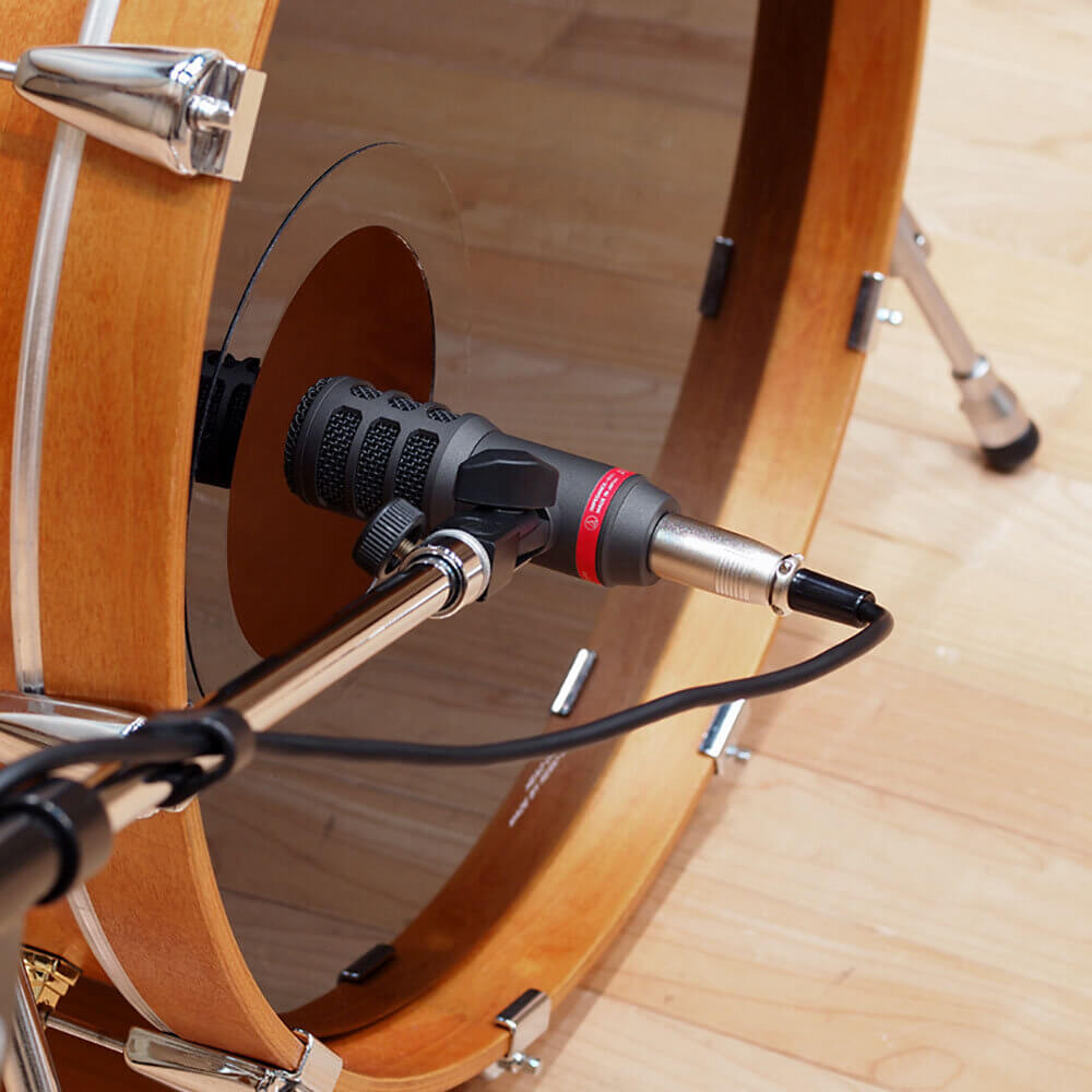 Audio-Technica ATM25 - Hypercardioid Dynamic Instrument Microphone with an integral stand clamp, mounted in front of a kick drum