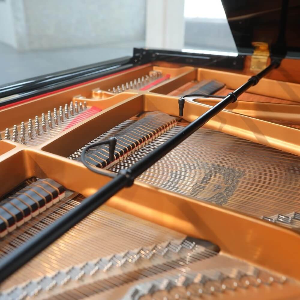 Close-up of the interior of a grand piano, showing the Earthworks PM40 Piano Microphone System