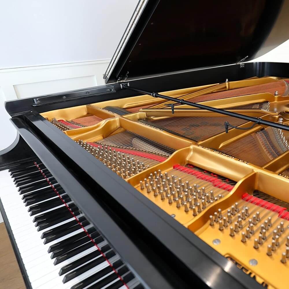 Close-up of a grand piano with the lid open, showing the Earthworks PM40 Piano Microphone System