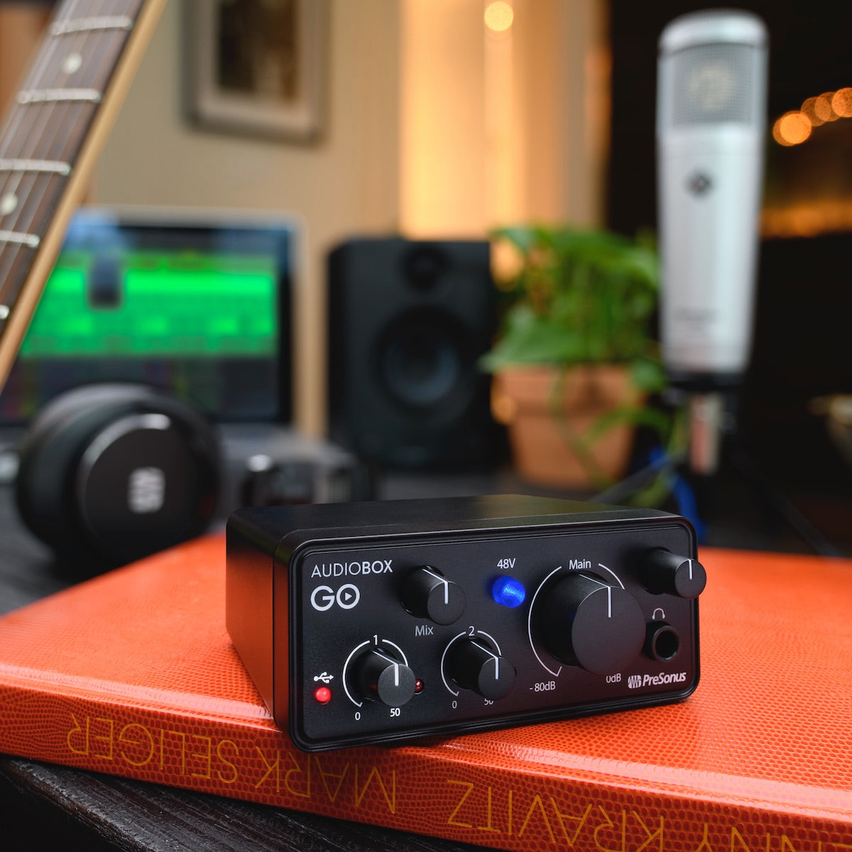 PreSonus AudioBox GO - Ultra-compact Mobile 2x2 USB Audio Interface, shown in a podcast setting